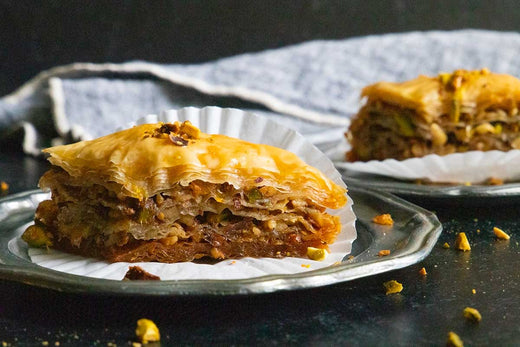 Crispy baklava with hazelnuts, elegantly served and drizzled with syrup.