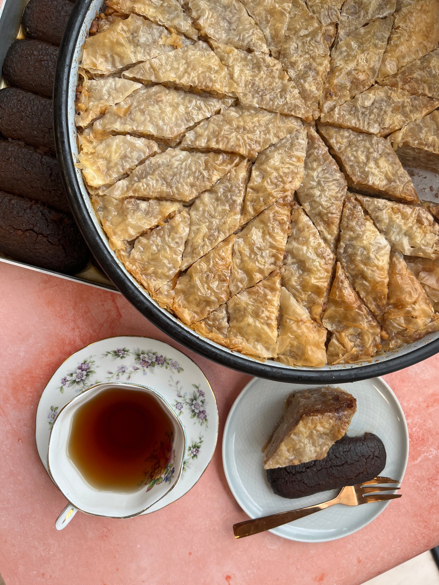 Traditional baklava served with a cup of tea, a perfect pairing.