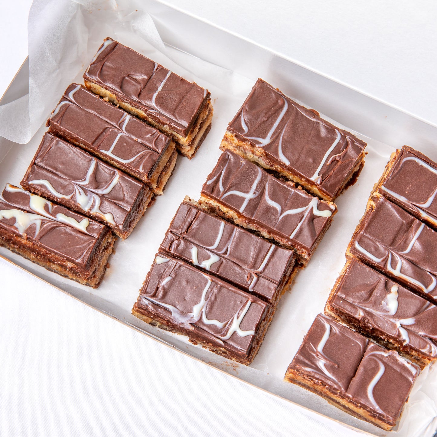 Balkan dessert Bajadera with rich chocolate and nut layers.